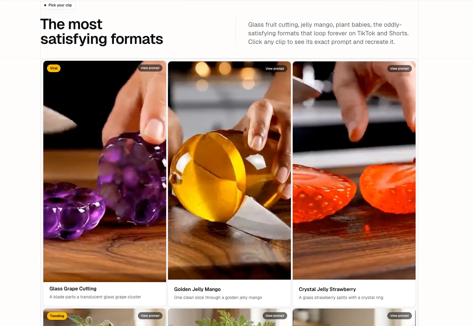 The free AI ASMR generator's template library showing glass grape cutting, golden jelly mango, and crystal jelly strawberry clips, each with a View prompt button