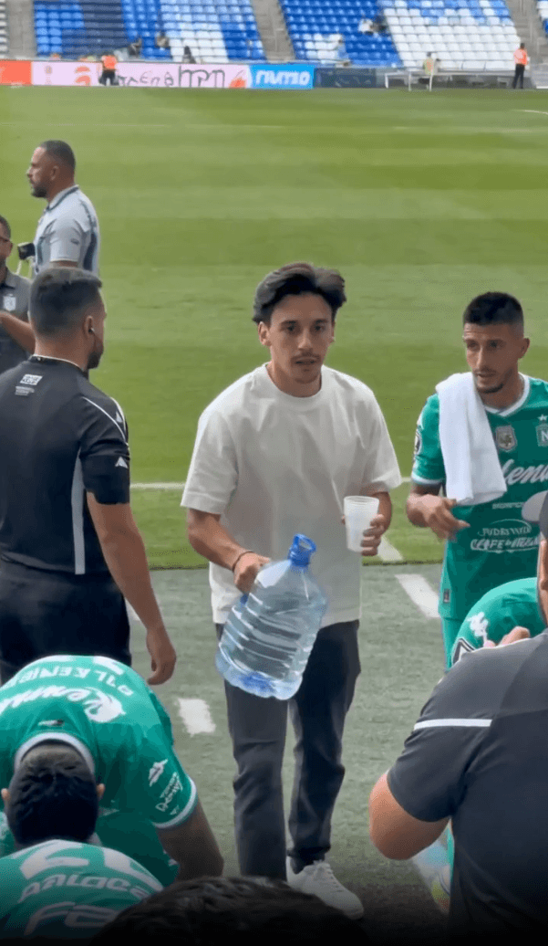 A video frame of the real man pitchside at a stadium, his face clearly recognisable.